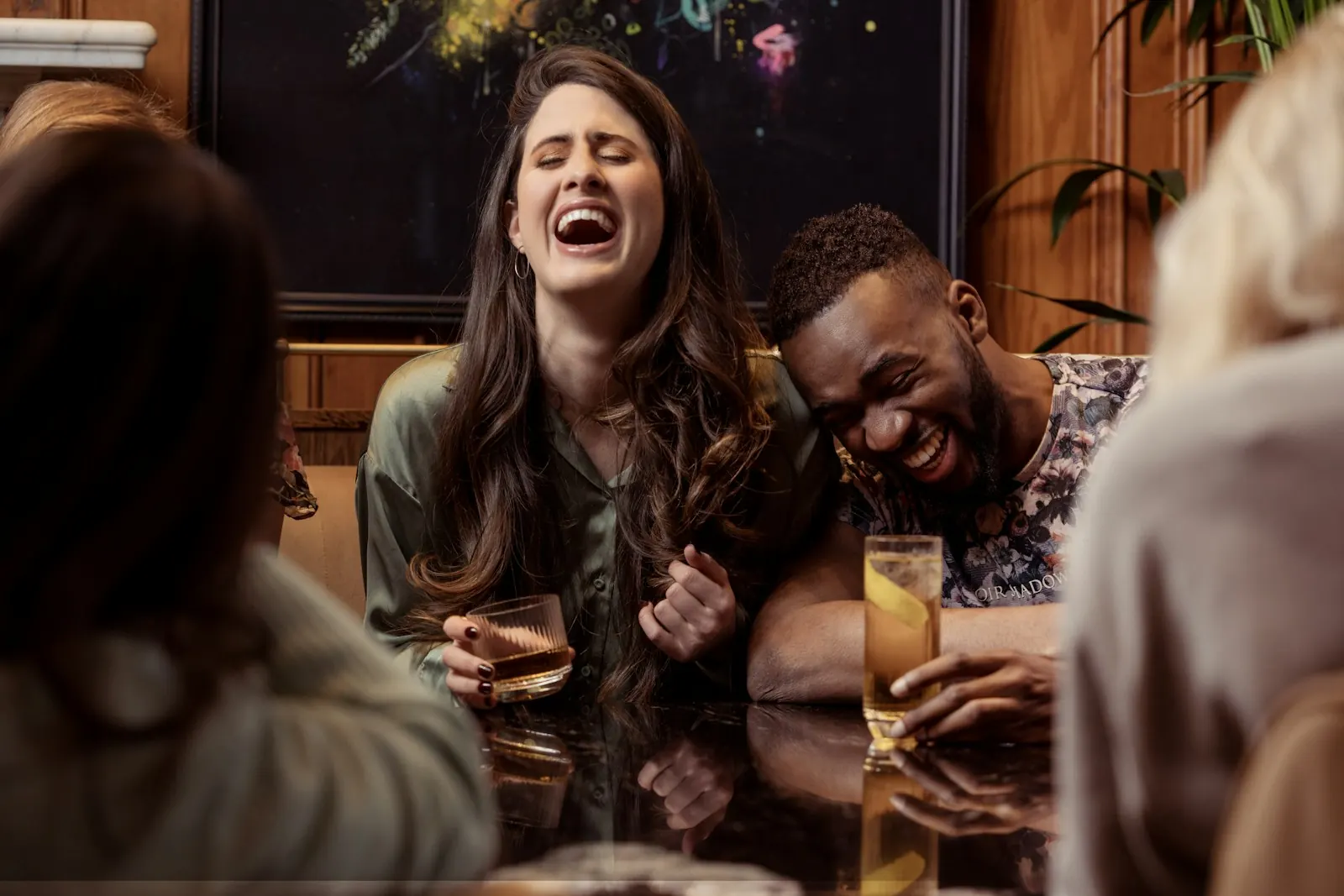Friends laughing together around a table