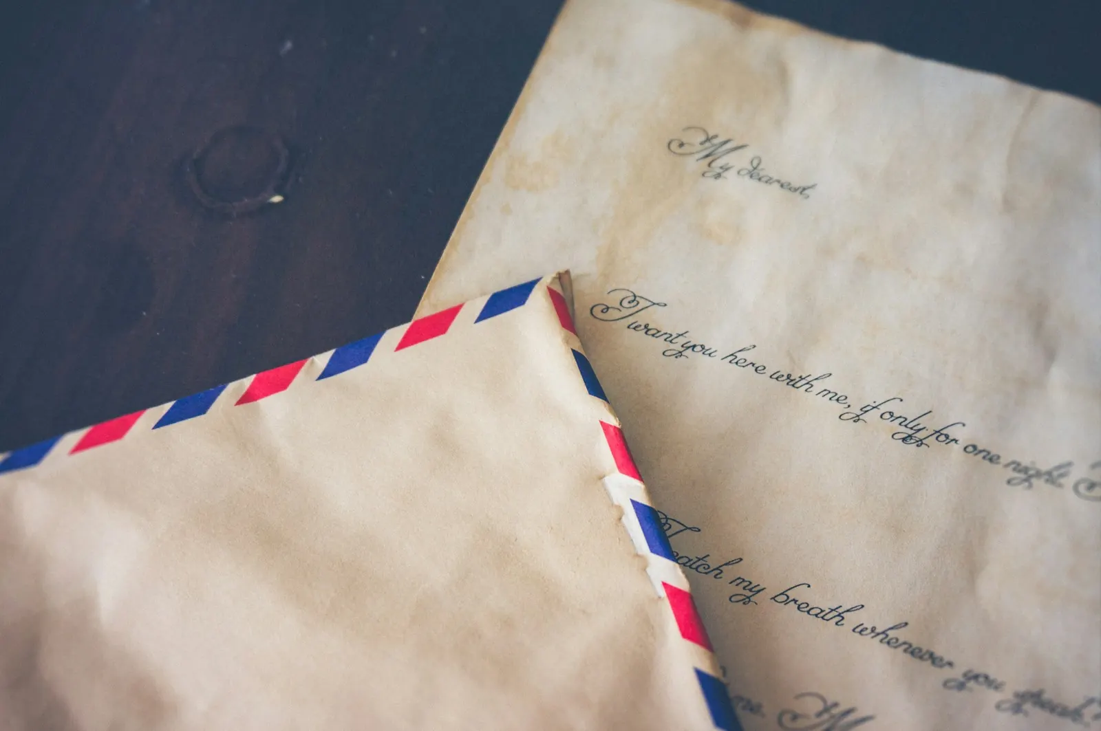 Handwritten letter beside a vintage airmail envelope