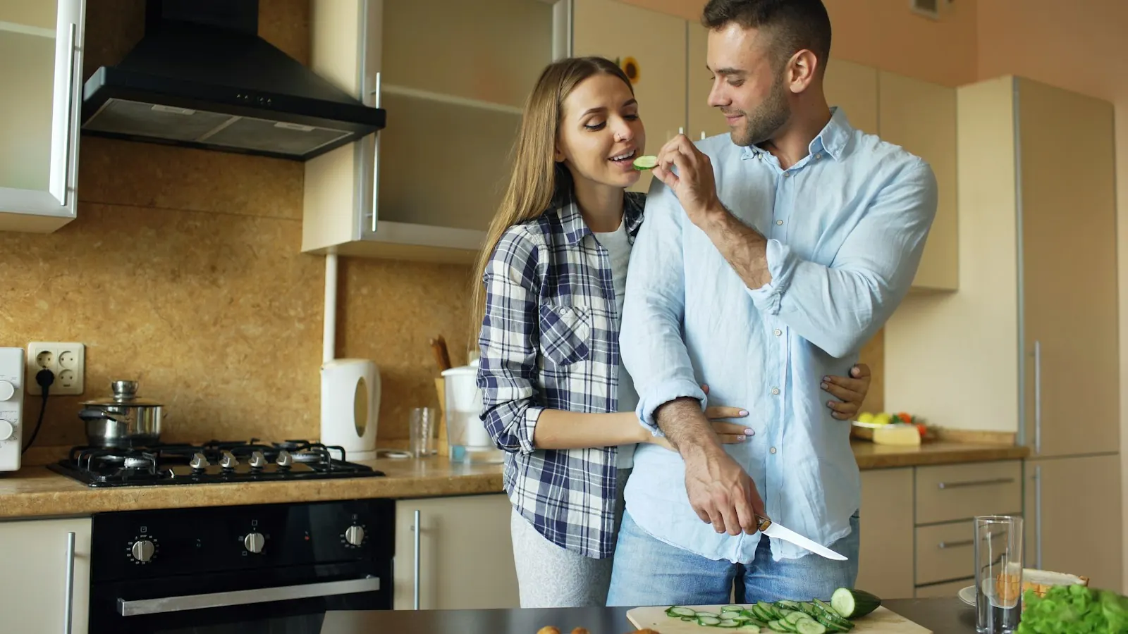 Couple cooking breakfast together in their kitchen