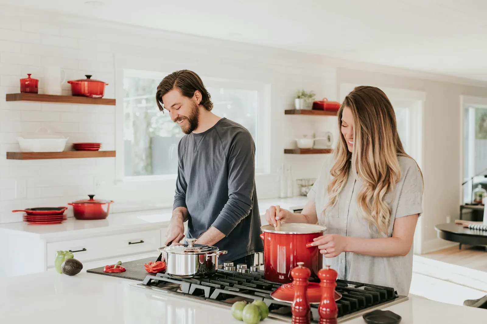 Couple cooking side by side in a bright kitchen